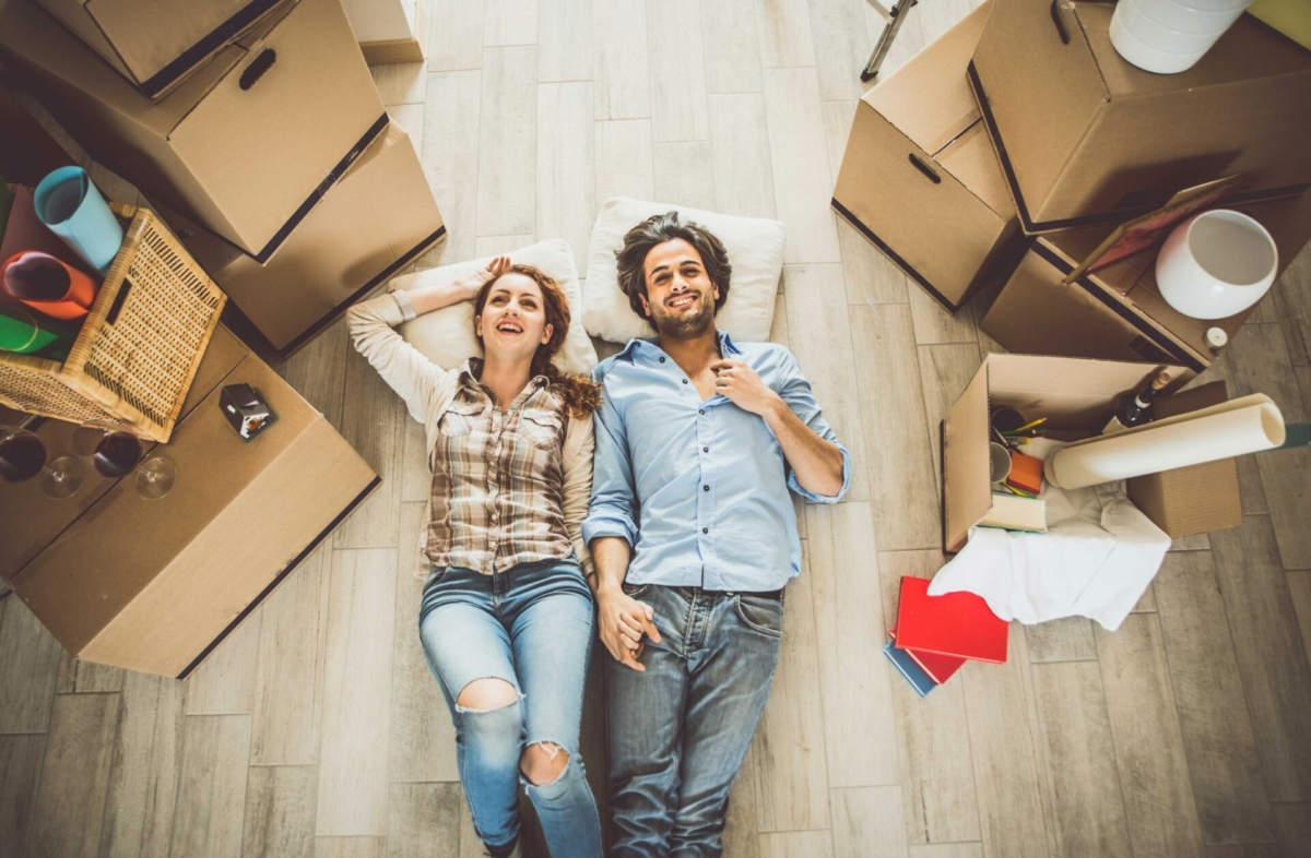 A couple laying on the floor in new house.