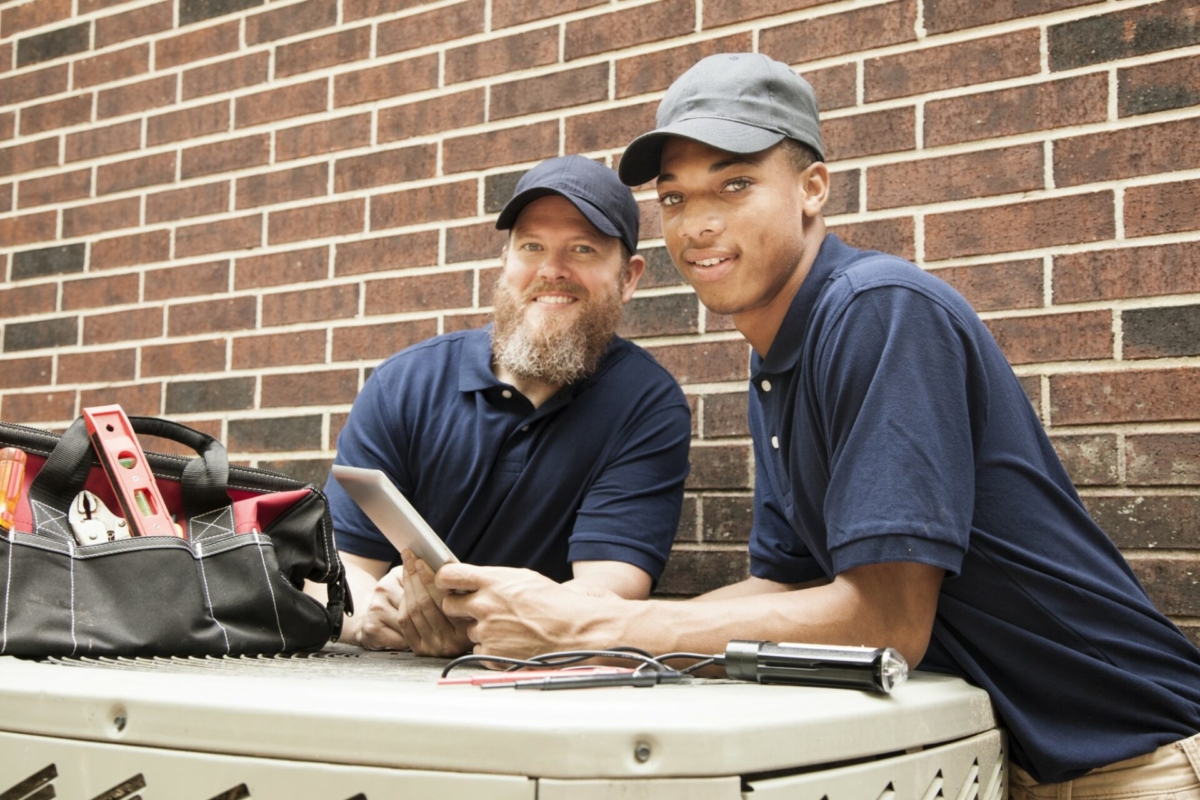 Two service providers refer to information on a tablet.