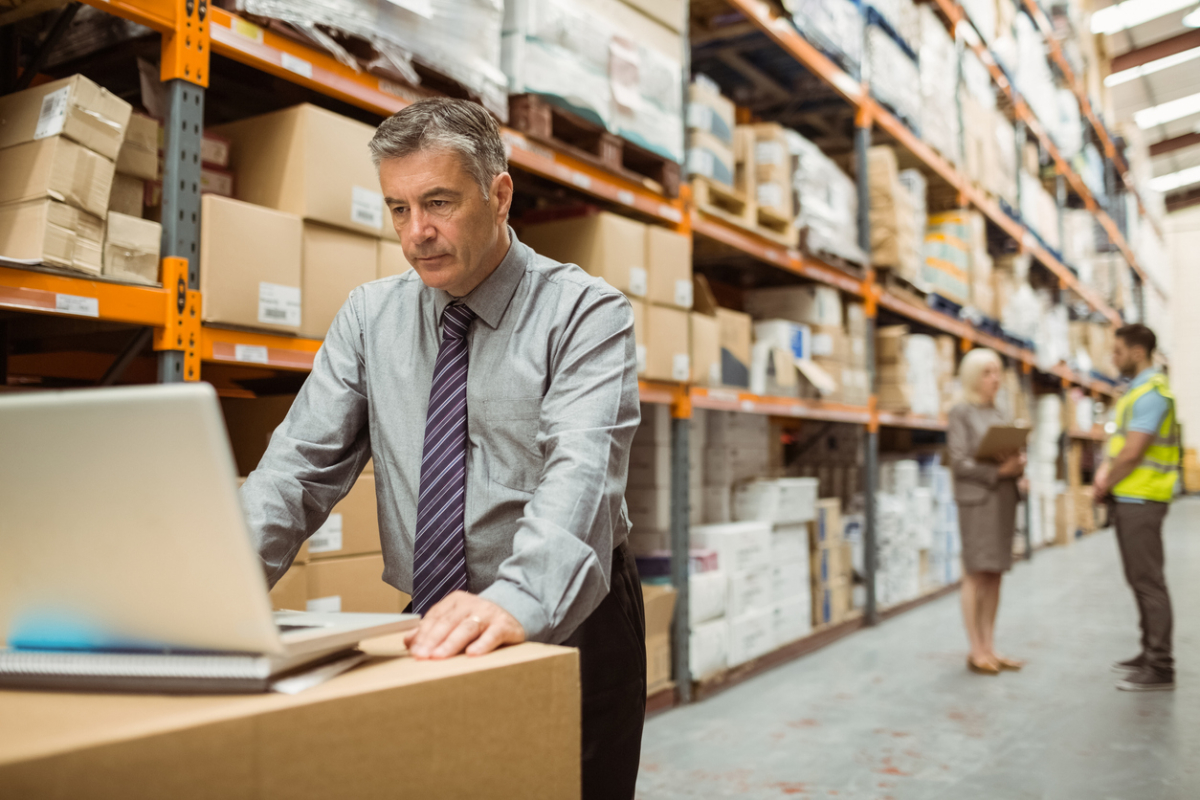A warehouse manager uses a computer to track inventory