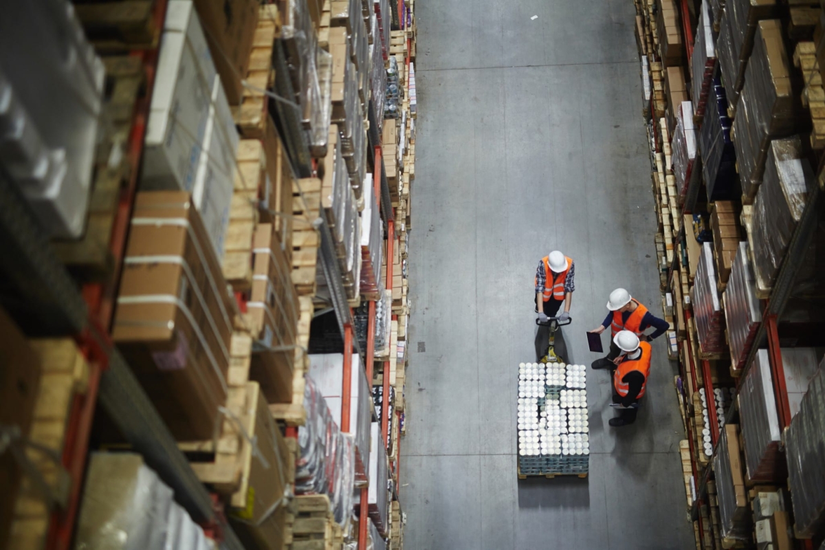 Employees practicing inventory control with a tablet.