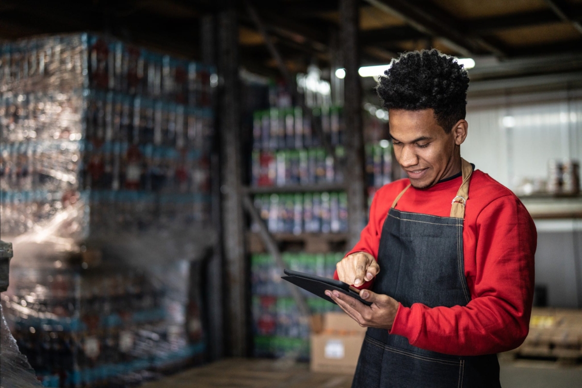A man takes physical inventory in a warehouse.