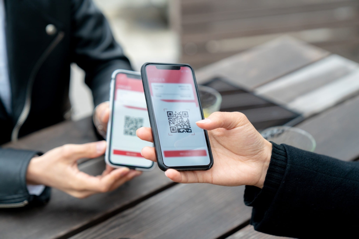 Two people barcode scanning on smartphones.