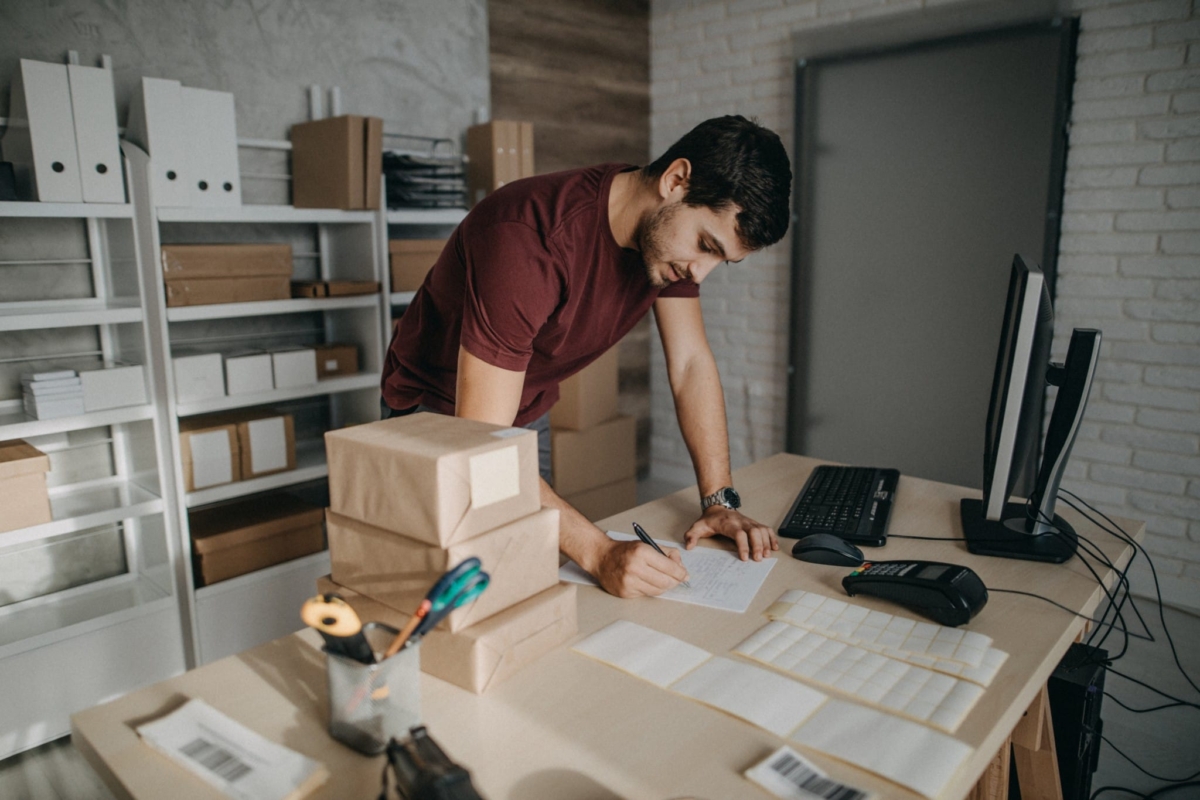 A man works with barcodes at a small business.