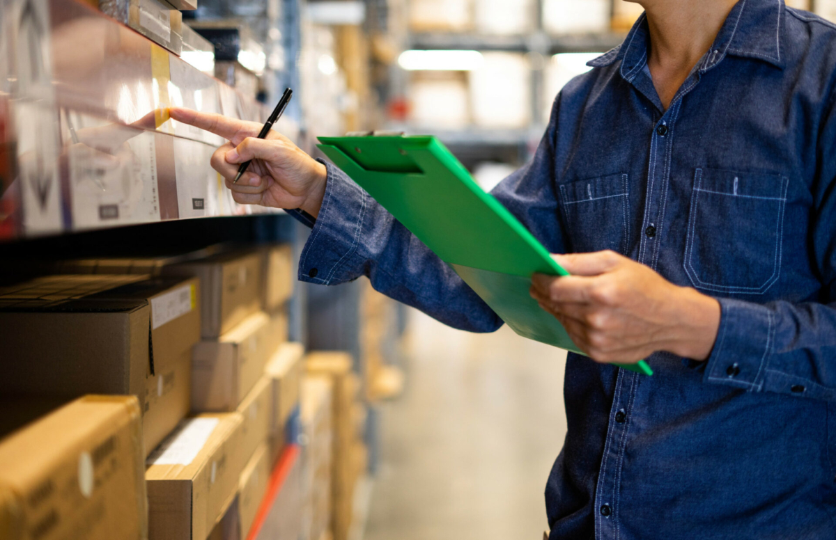 A person takes physical inventory on a clipboard.