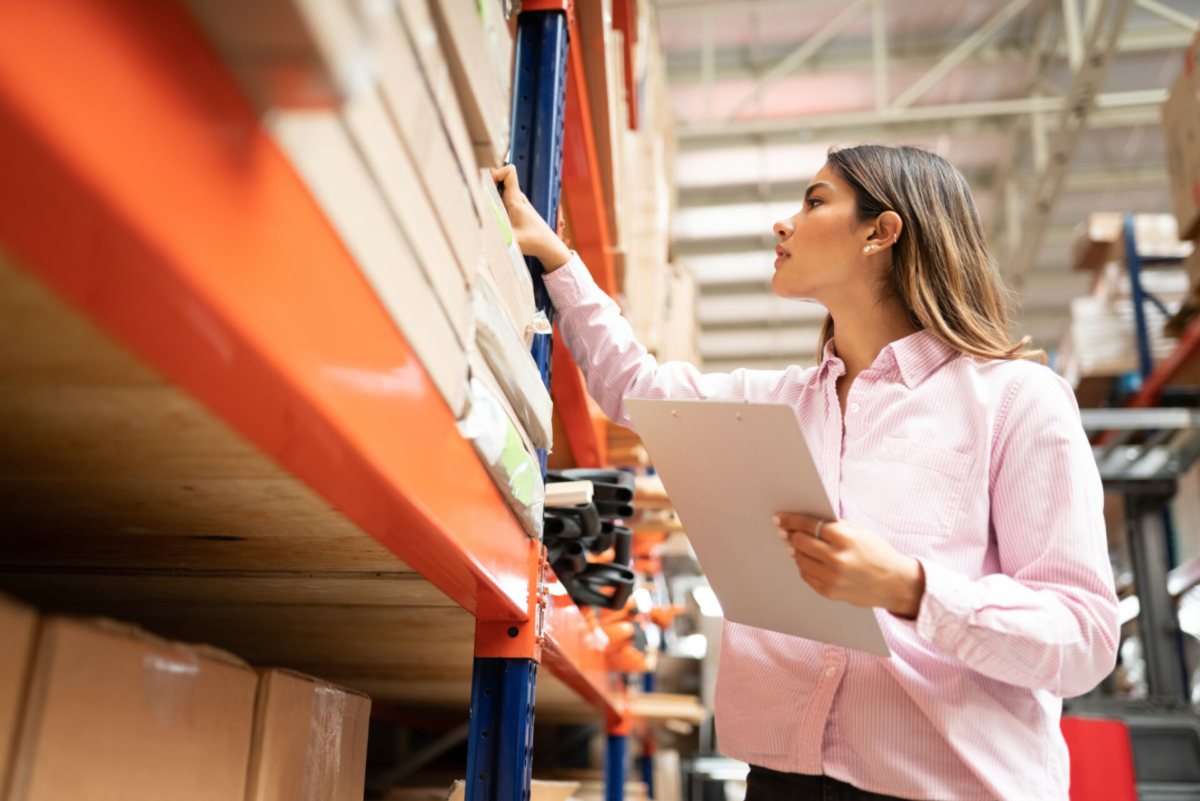 A woman takes inventory in a stockroom.