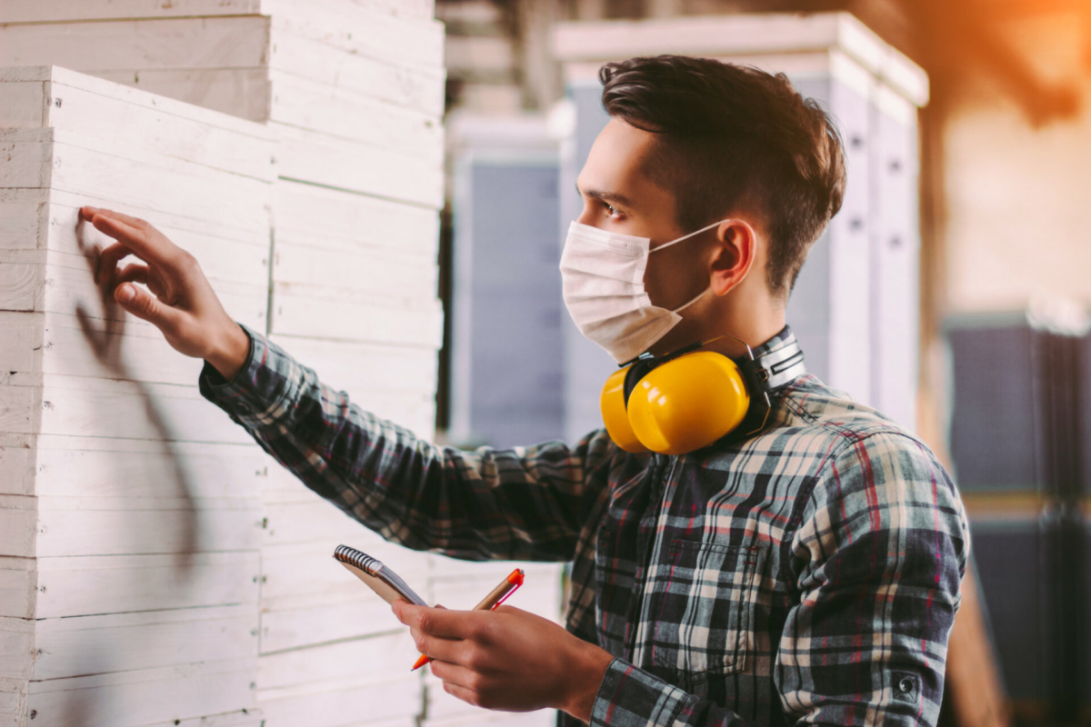 A man takes inventory wearing a mask.