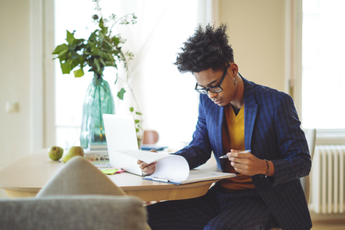 A man takes inventory at his work-from-home desk.