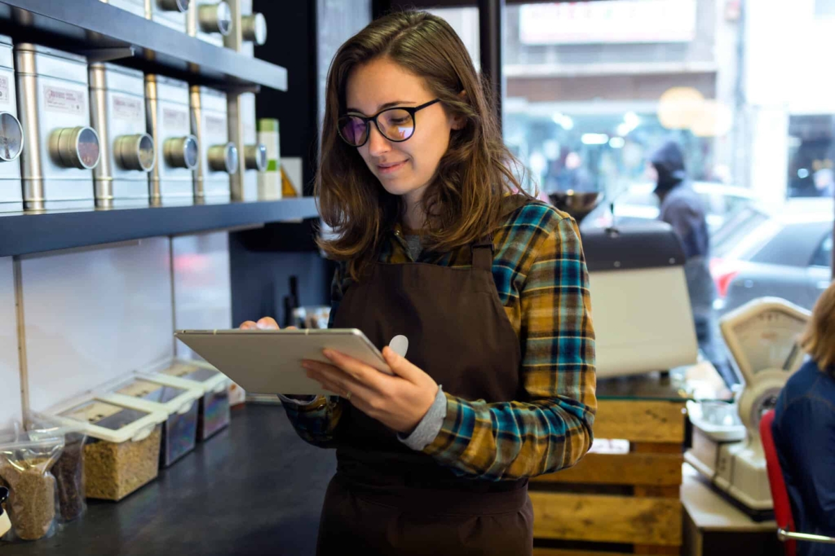 An associate checks inventory on a balance sheet.