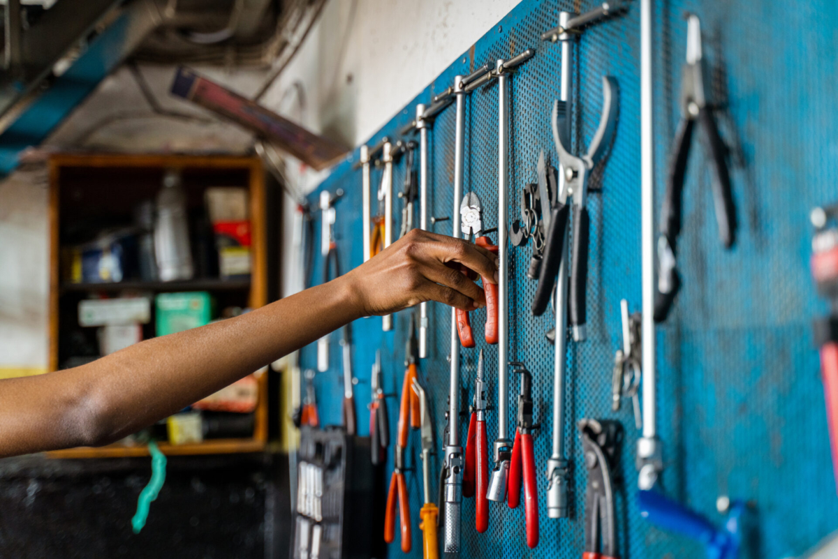 A worker reaching for tools.