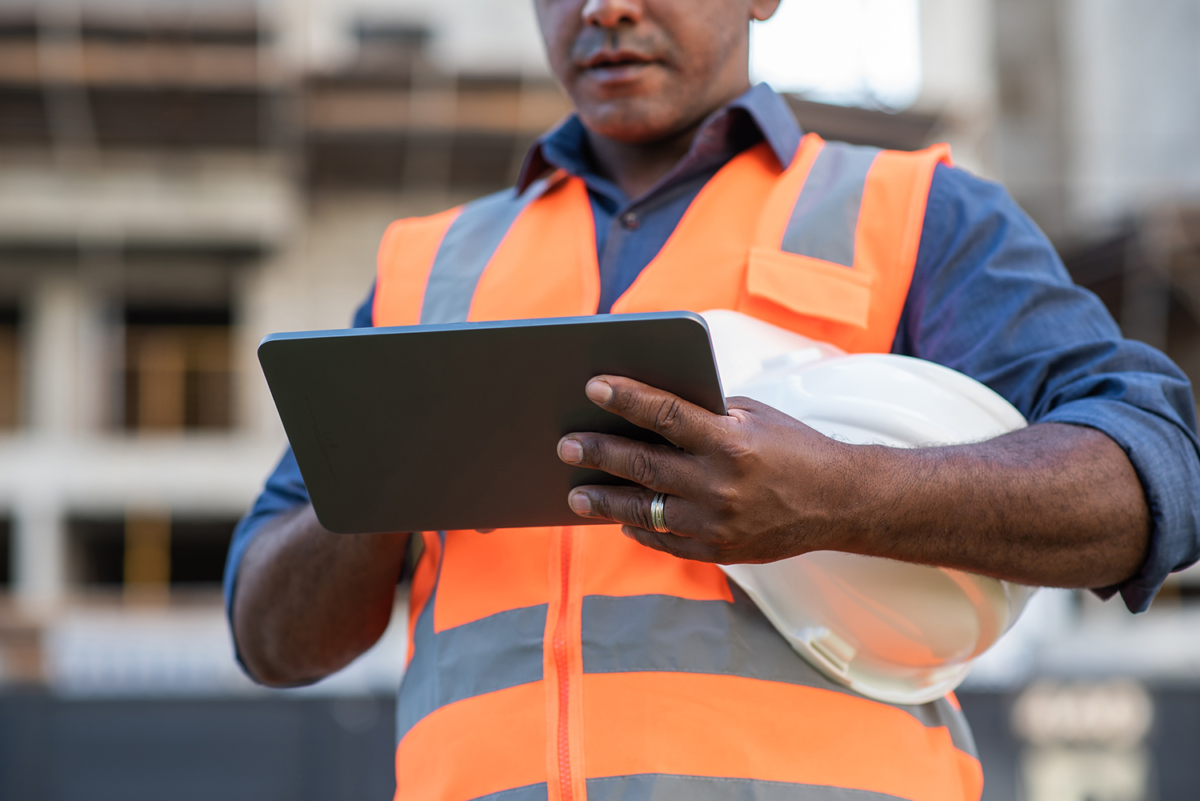 man holding tablet - inventory management benefits for construction