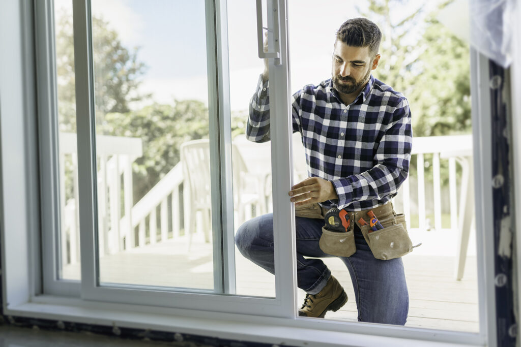 male construction worker installing a door - demand planning