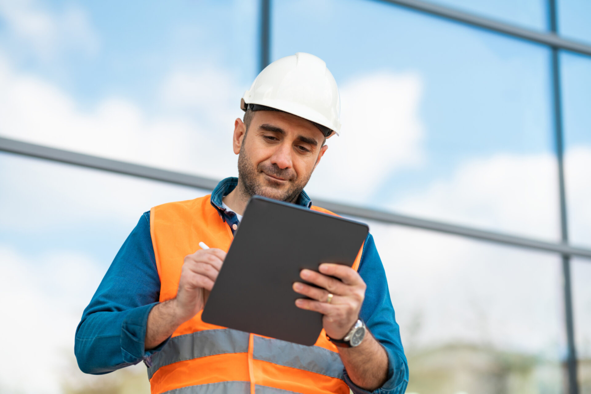 Man tracking inventory on table - construction risk management