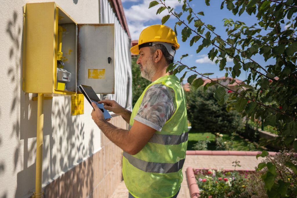 Man standing at electrical box - construction risk management