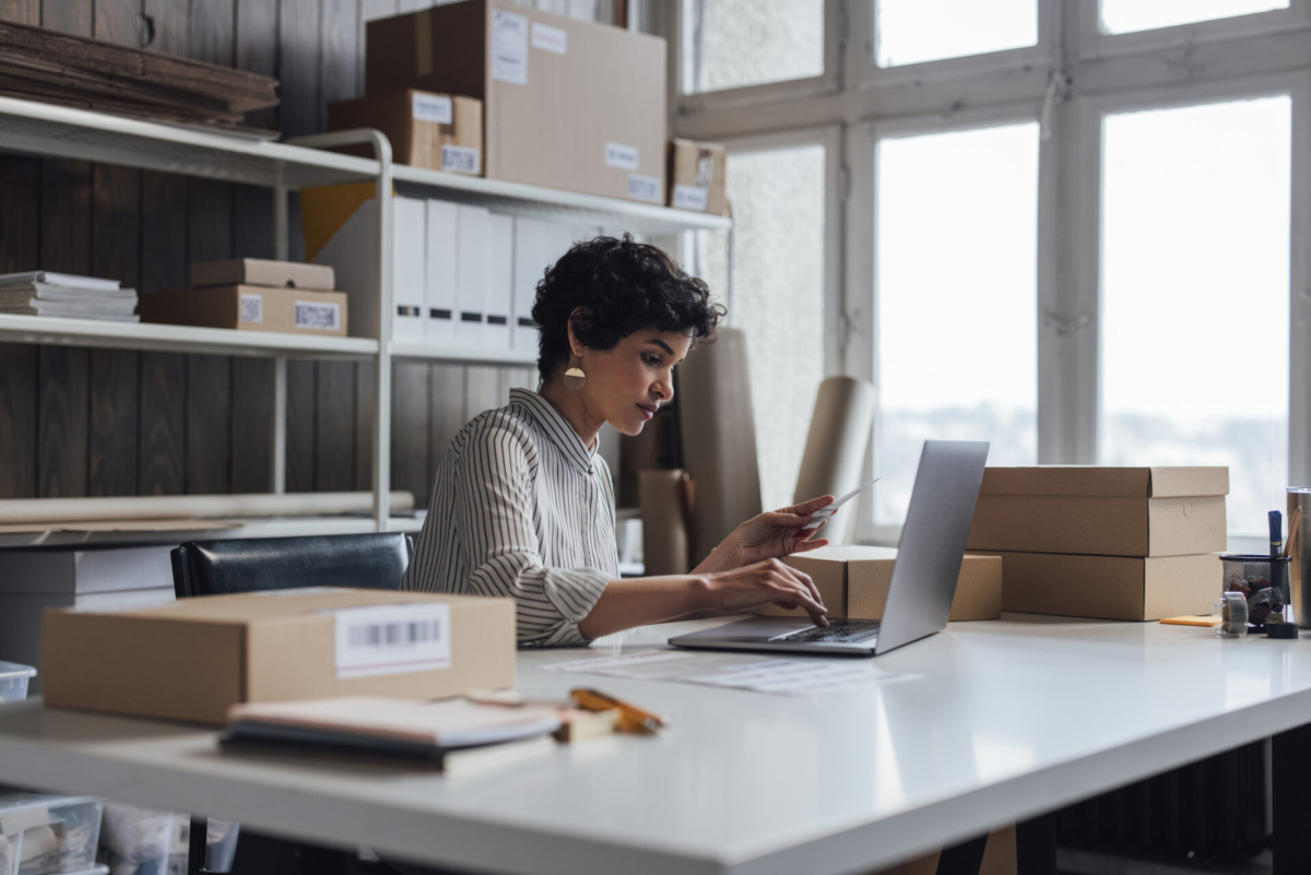 A woman organizing her business on a laptop