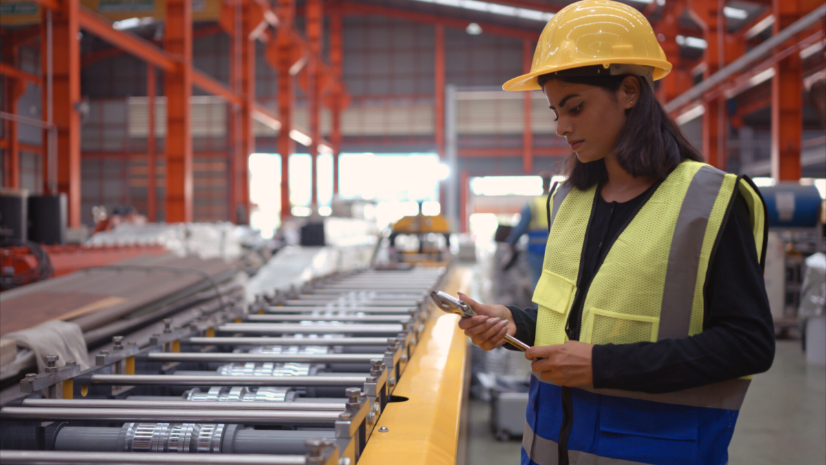 A female employee inspects work in process inventory