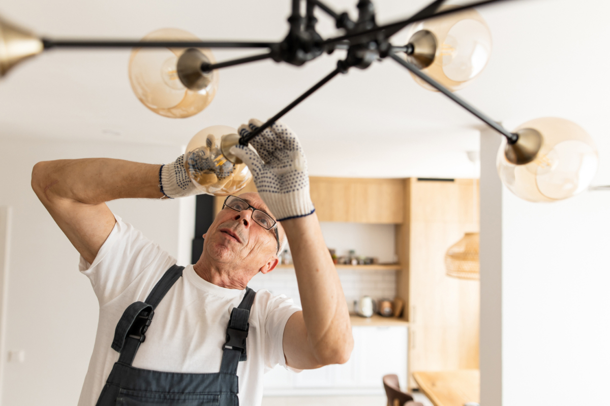 Man installing light fixture - interior design challenges