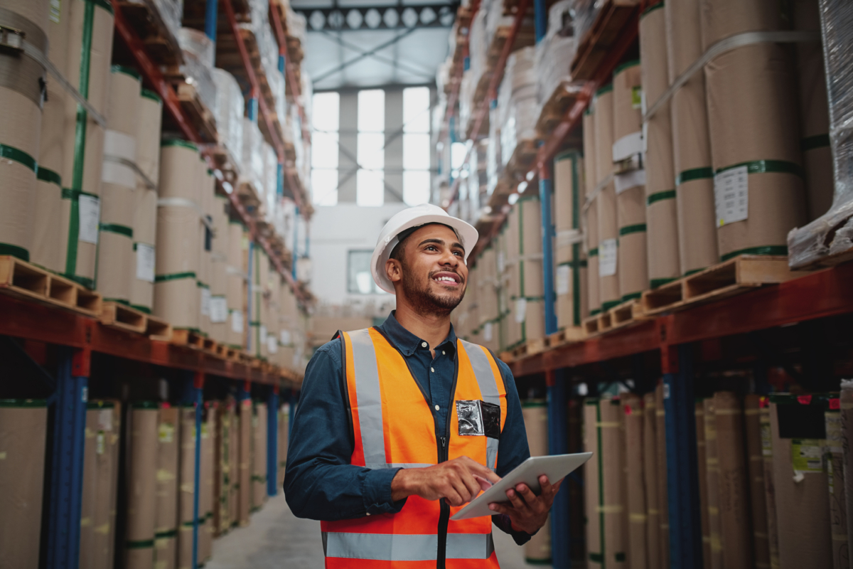 Male employee smiling in warehouse