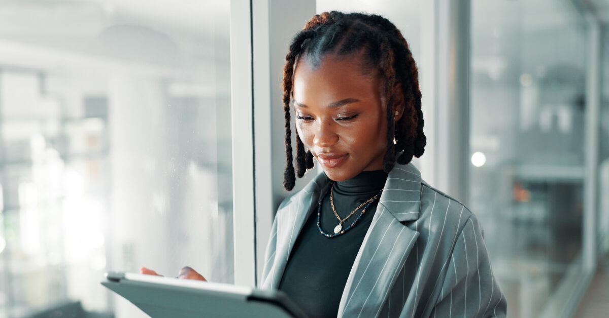 A woman uses a software asset management tool on a tablet.