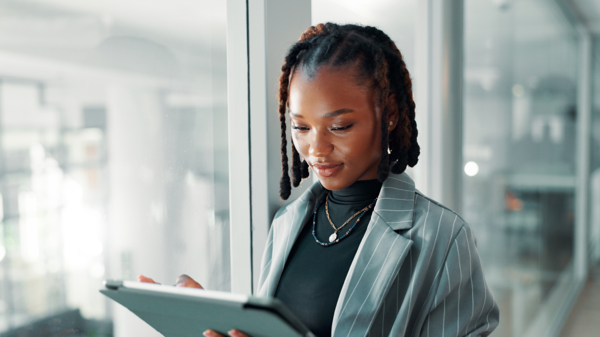 A woman uses a software asset management tool on a tablet.