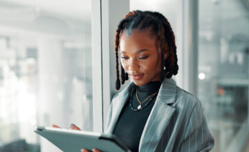 A woman uses a software asset management tool on a tablet.