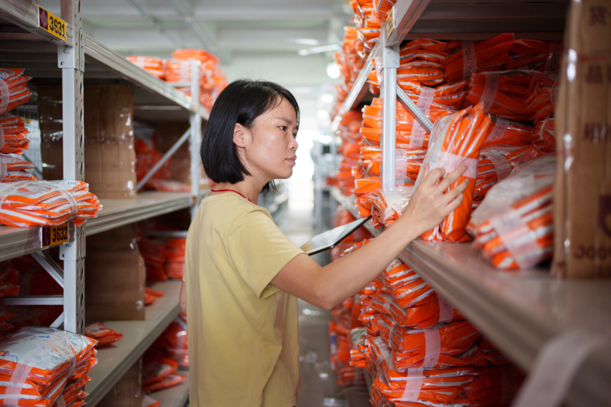 A woman reviews kitted inventory.
