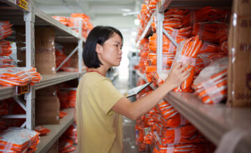 A woman reviews kitted inventory.