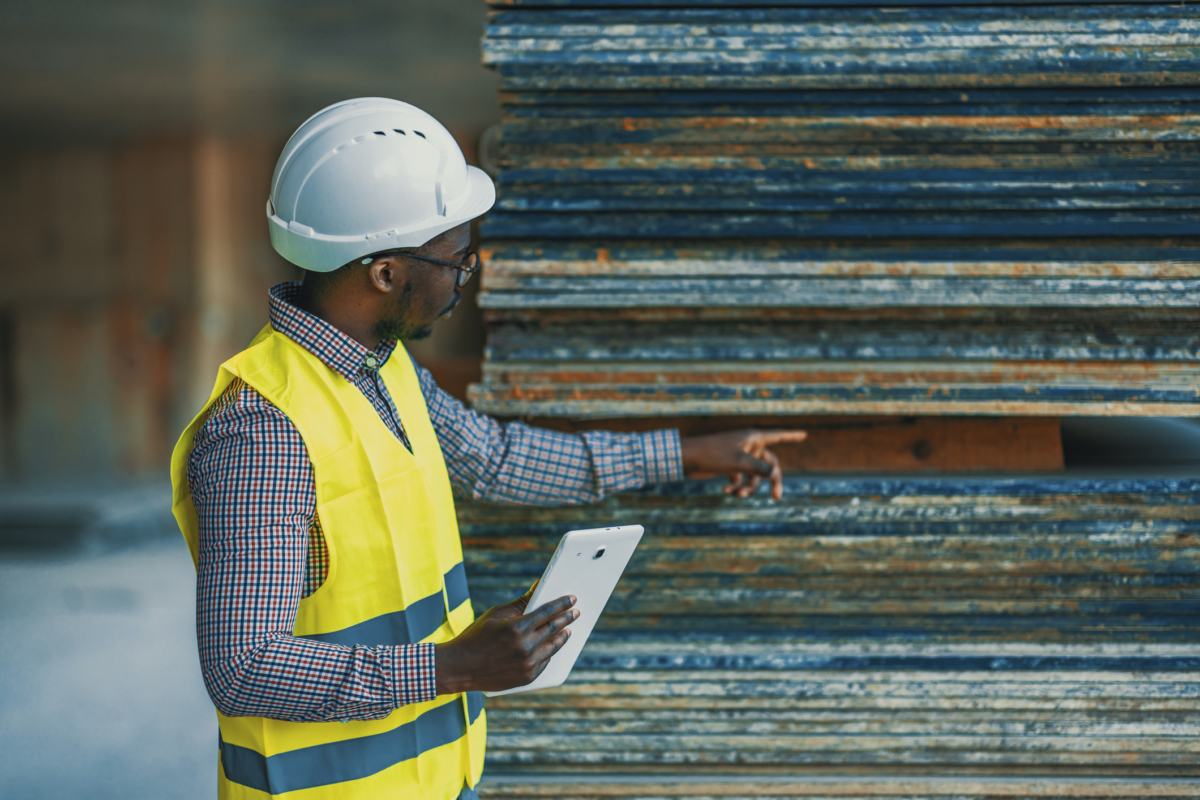 A man reviews raw materials as part of a construction procurement process.