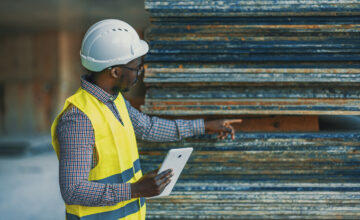 A man reviews raw materials as part of a construction procurement process.