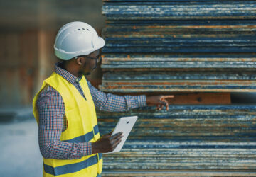 A man reviews raw materials as part of a construction procurement process.