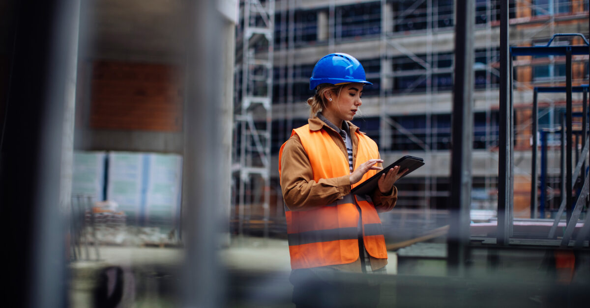 An employee manages construction equipment on a tablet.