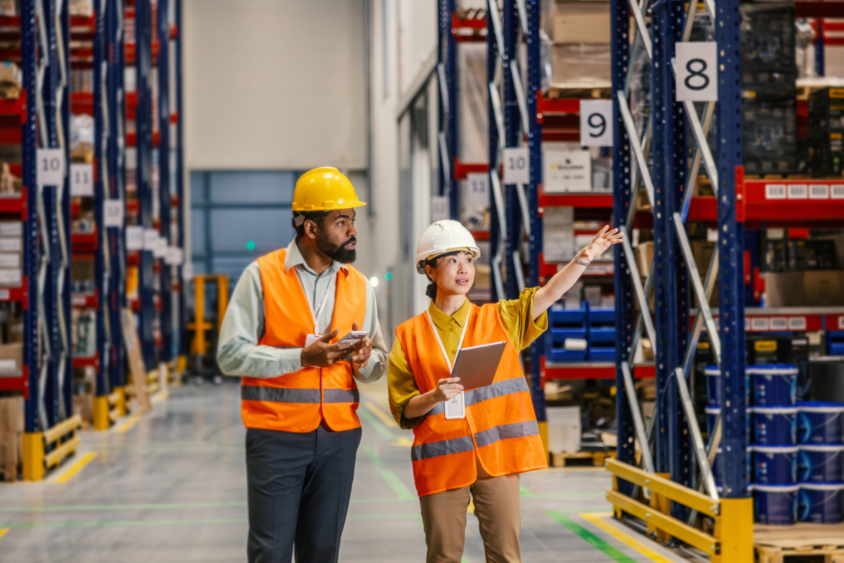 Two employees work together on the inventory management process.
