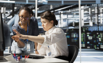 Two employees perform hardware asset management.