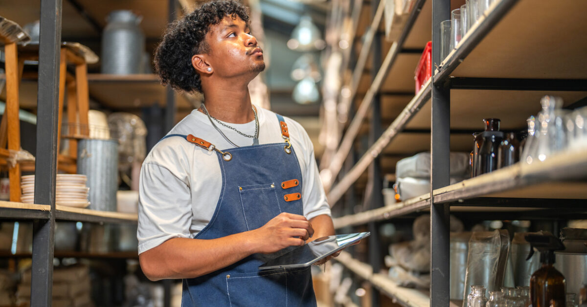 A man uses a tablet for remote asset management.