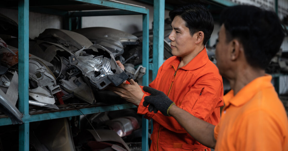 A team that uses parts inventory management software reviews spare parts.