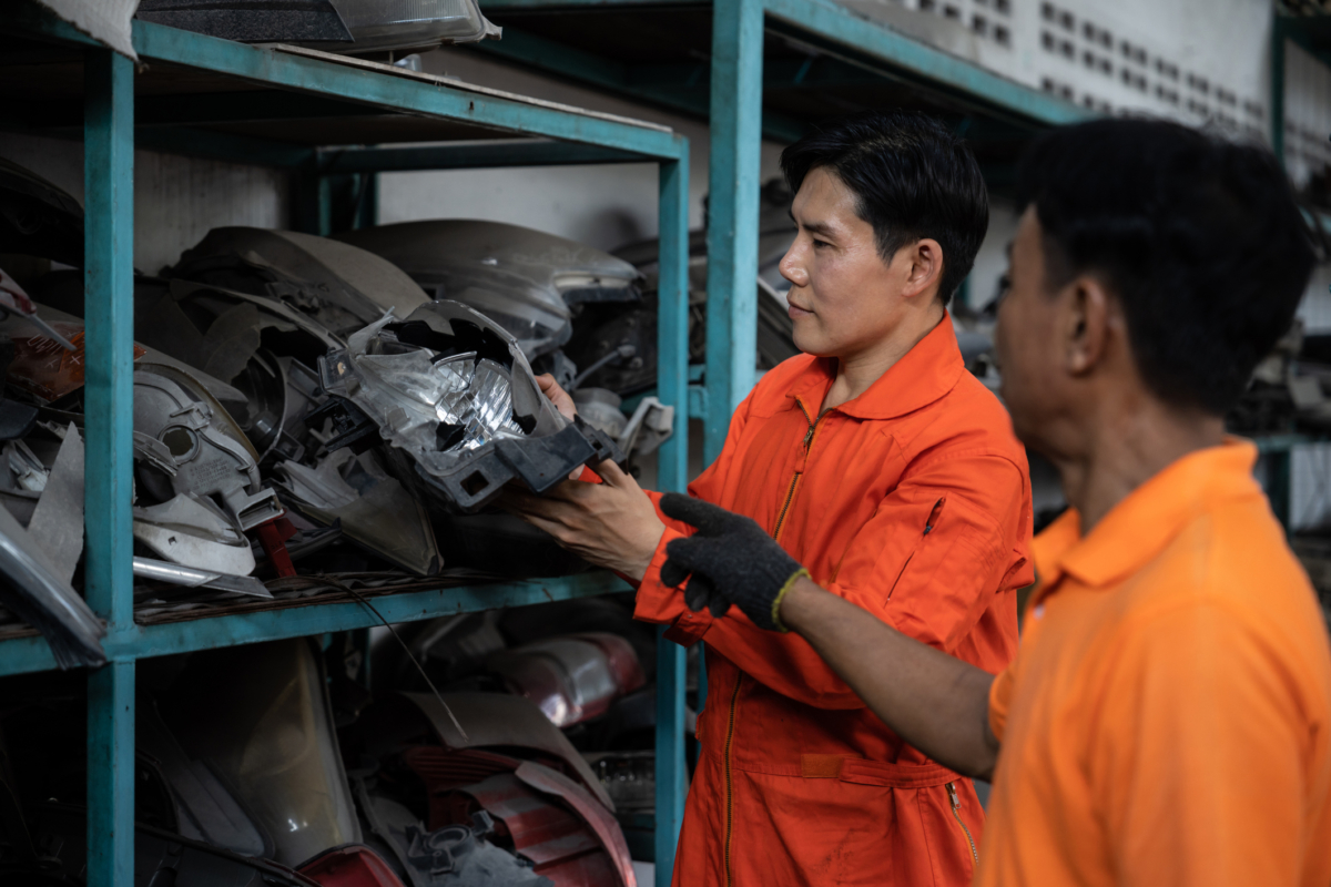 A team that uses parts inventory management software reviews spare parts.