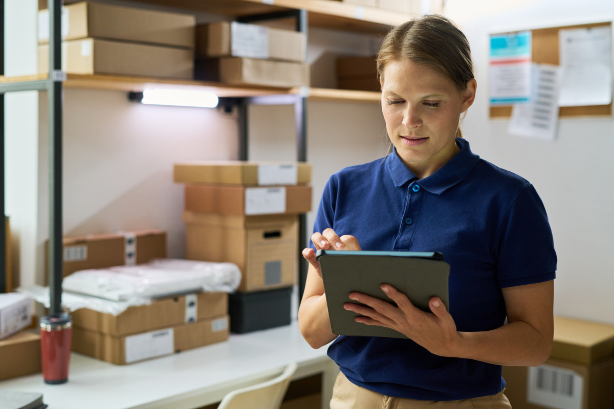 An employee uses asset management software for schools in a closet.